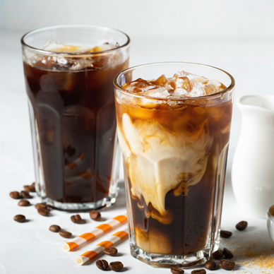 Ice,Coffee,In,A,Tall,Glass,With,Cream,Poured,Over